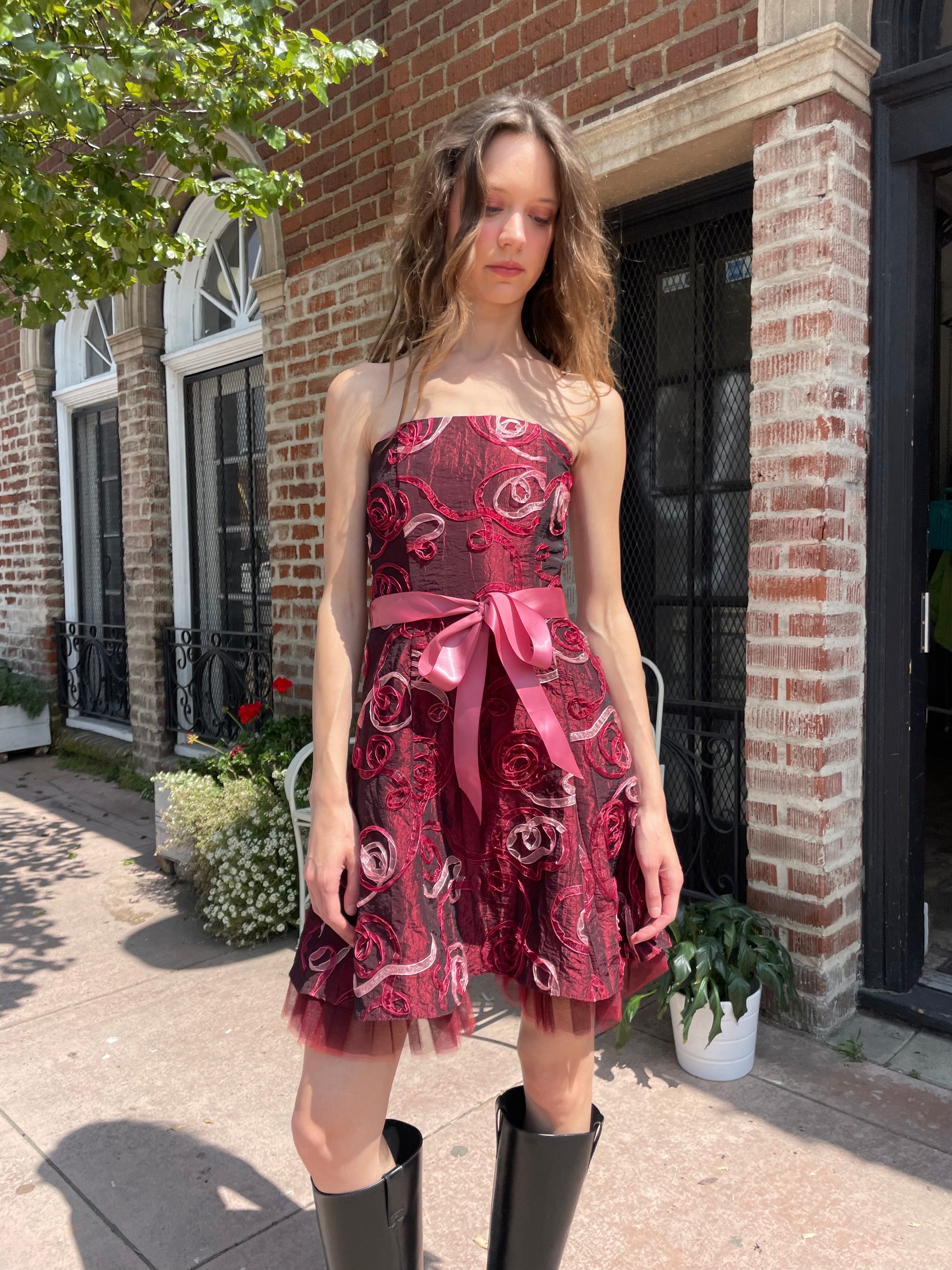 girl in strapless pink dress and black boots