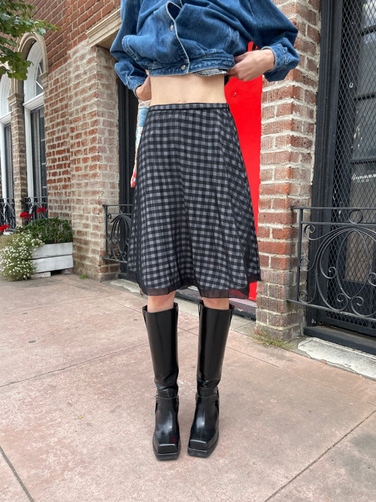 girl wearing denim jacket and gingham skirt