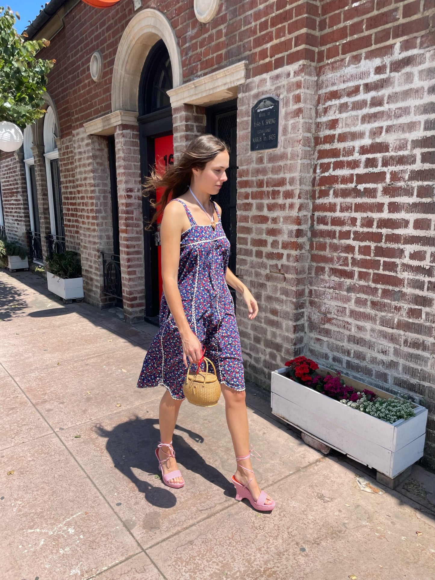 girl in blue floral sleeveless dress