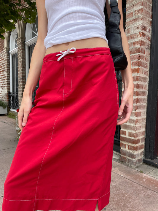 girl in red skirt and white tank top