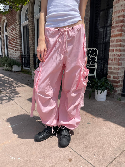 girl wearing baggy pink pants and white tank