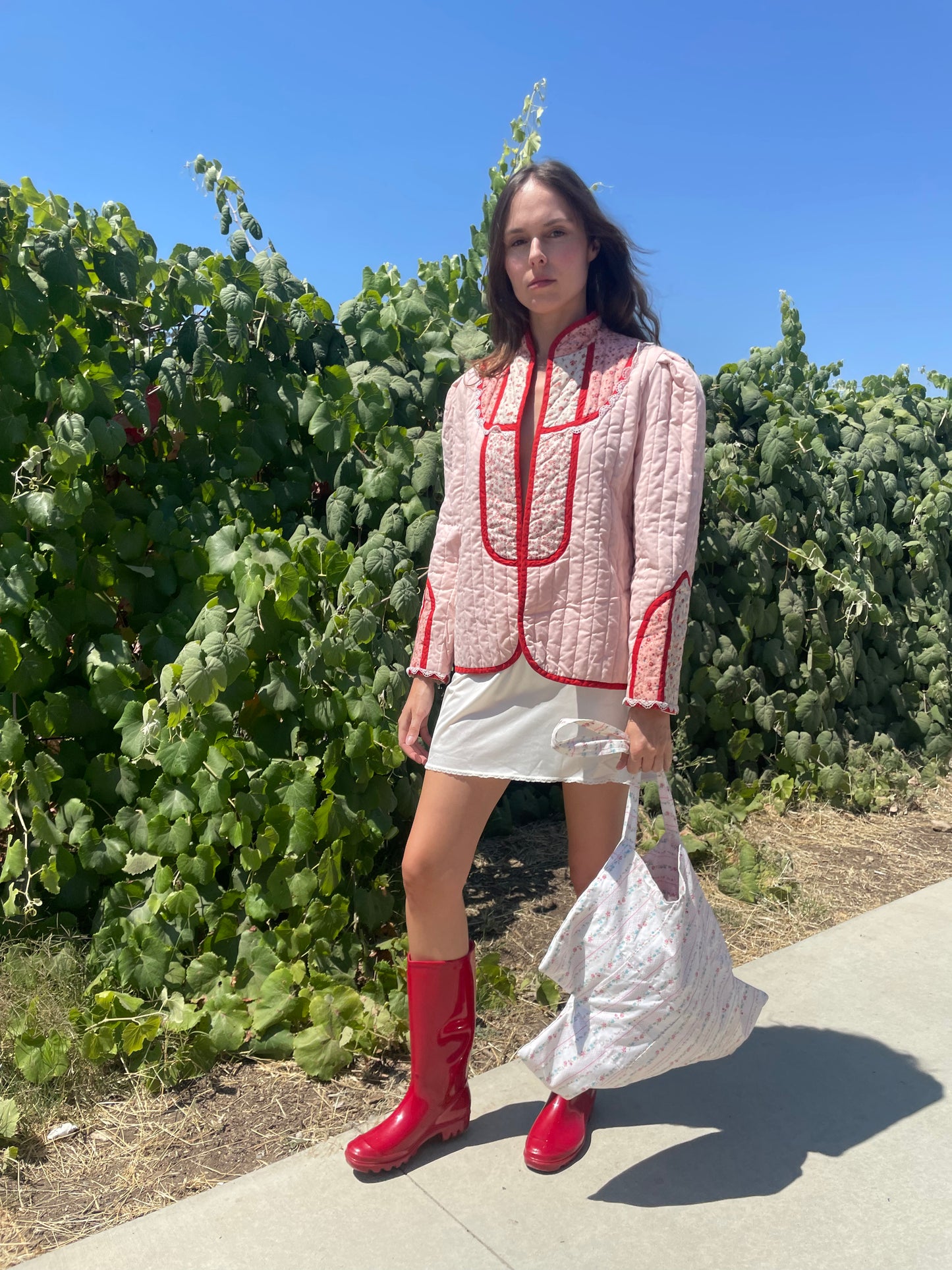 girl in pink jacket and white skirt