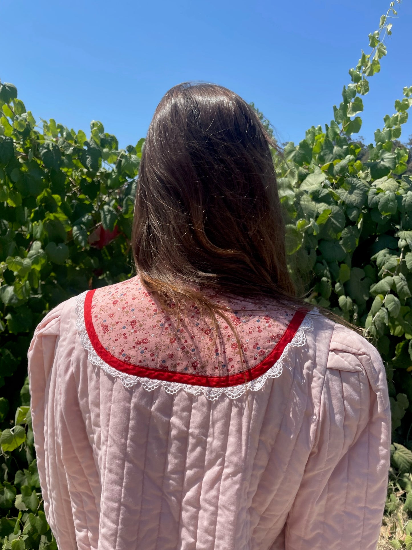 girl in pink jacket and white skirt