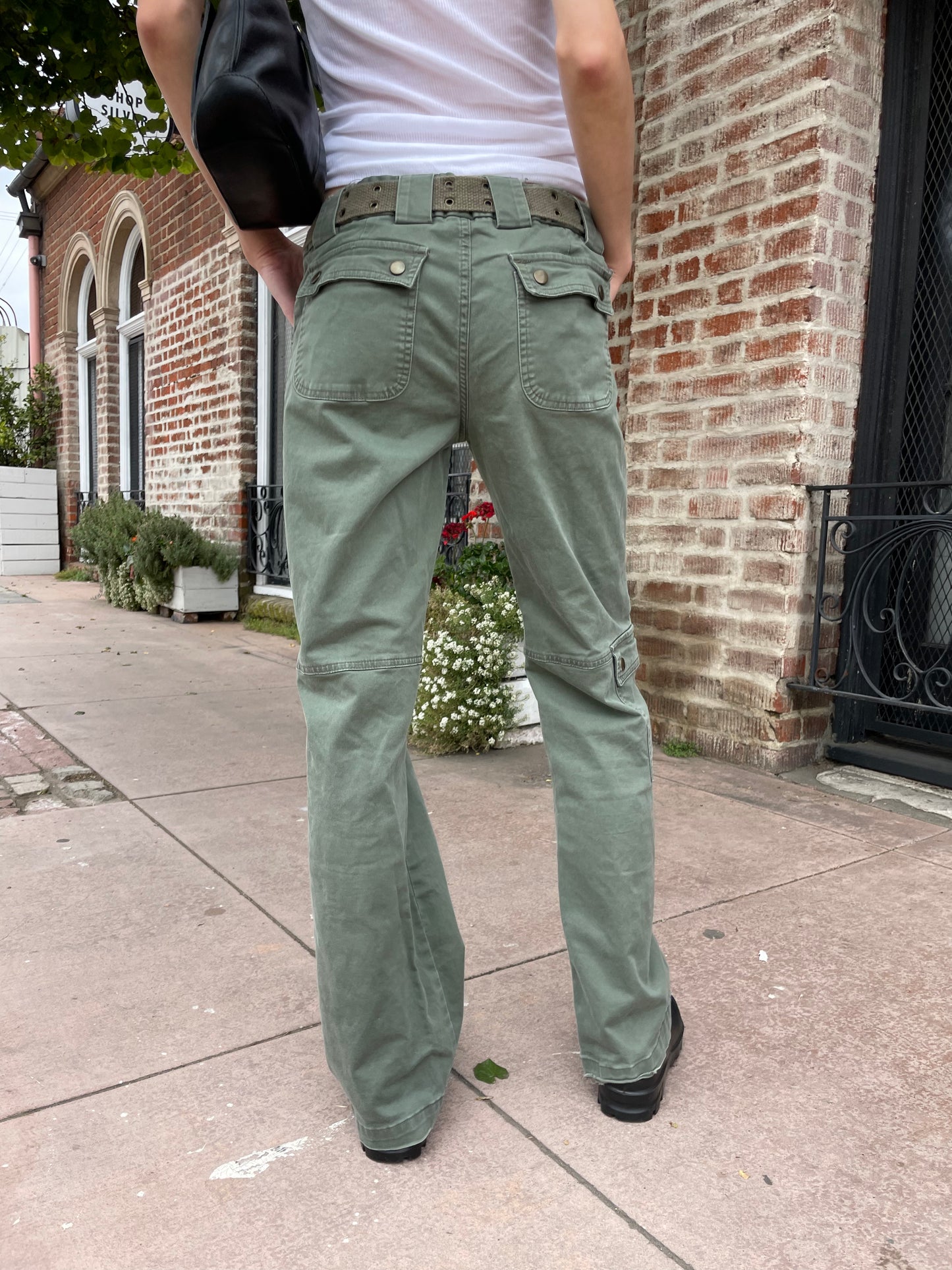 girl wearing white tank and green cargo pants