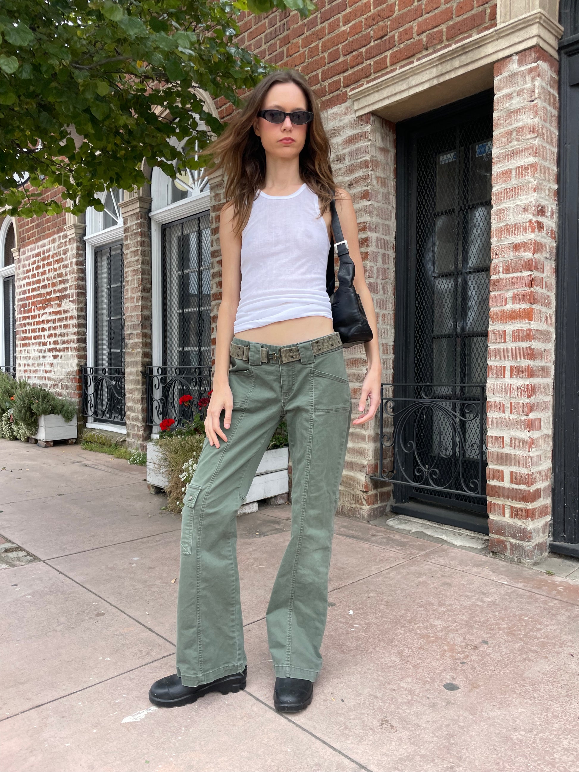 girl wearing white tank and green cargo pants