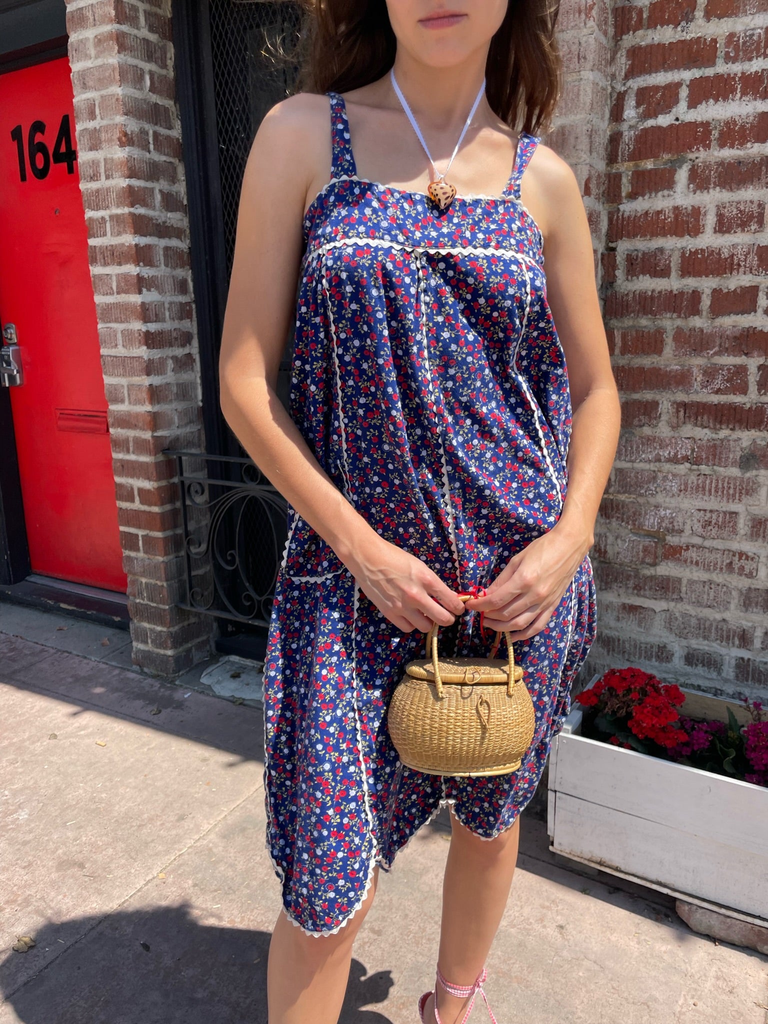 girl in blue floral sleeveless dress