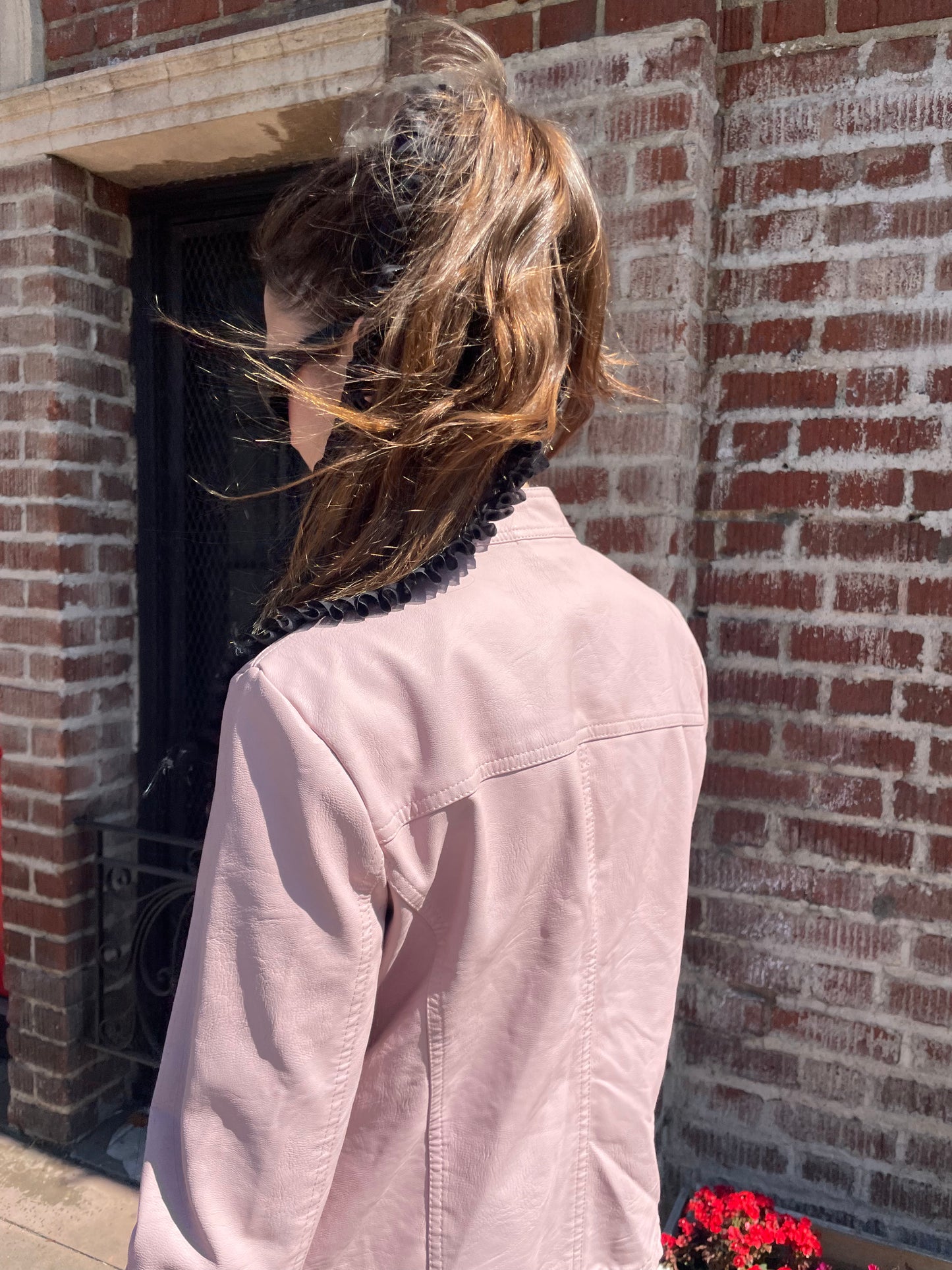 girl in plaid skirt and pink jacket