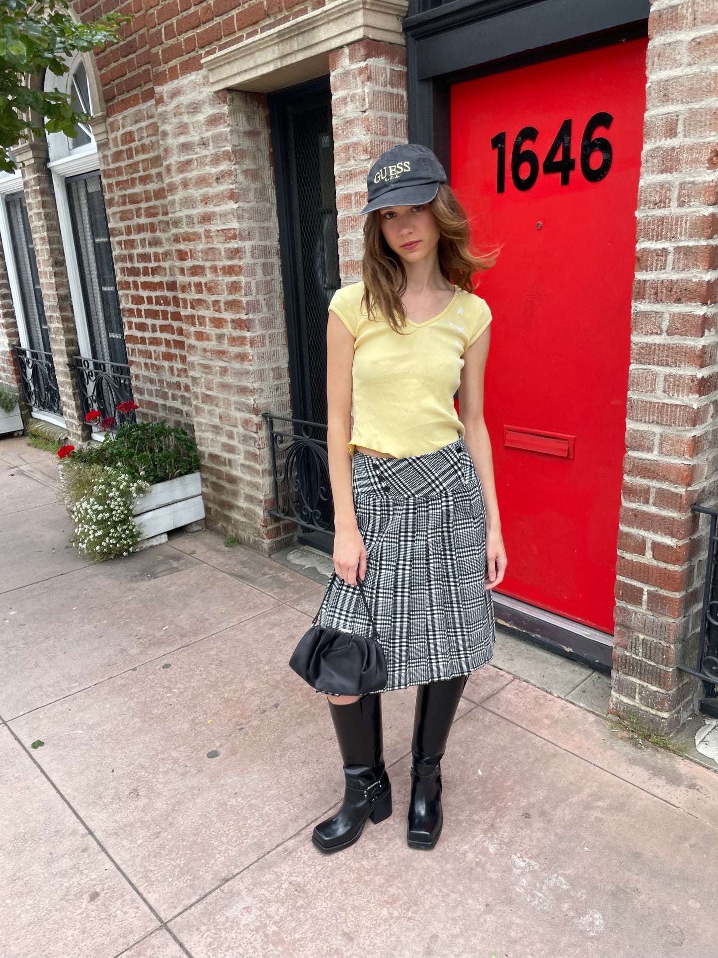 girl in yellow top and black and white skirt