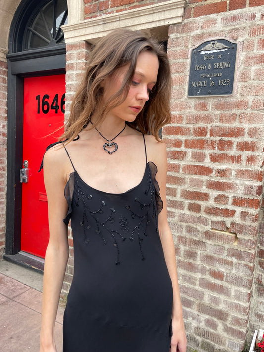 girl in black skinny strap dress