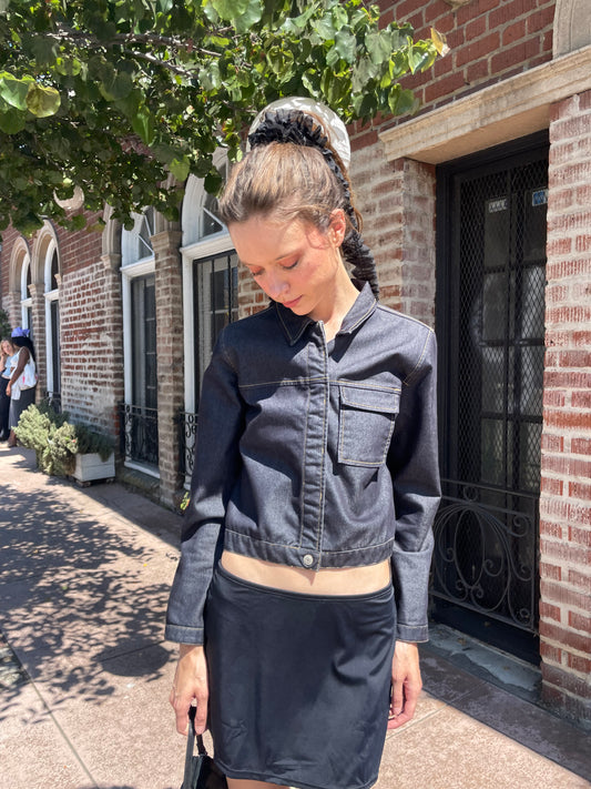 girl in denim jacket, black skirt and leather boots