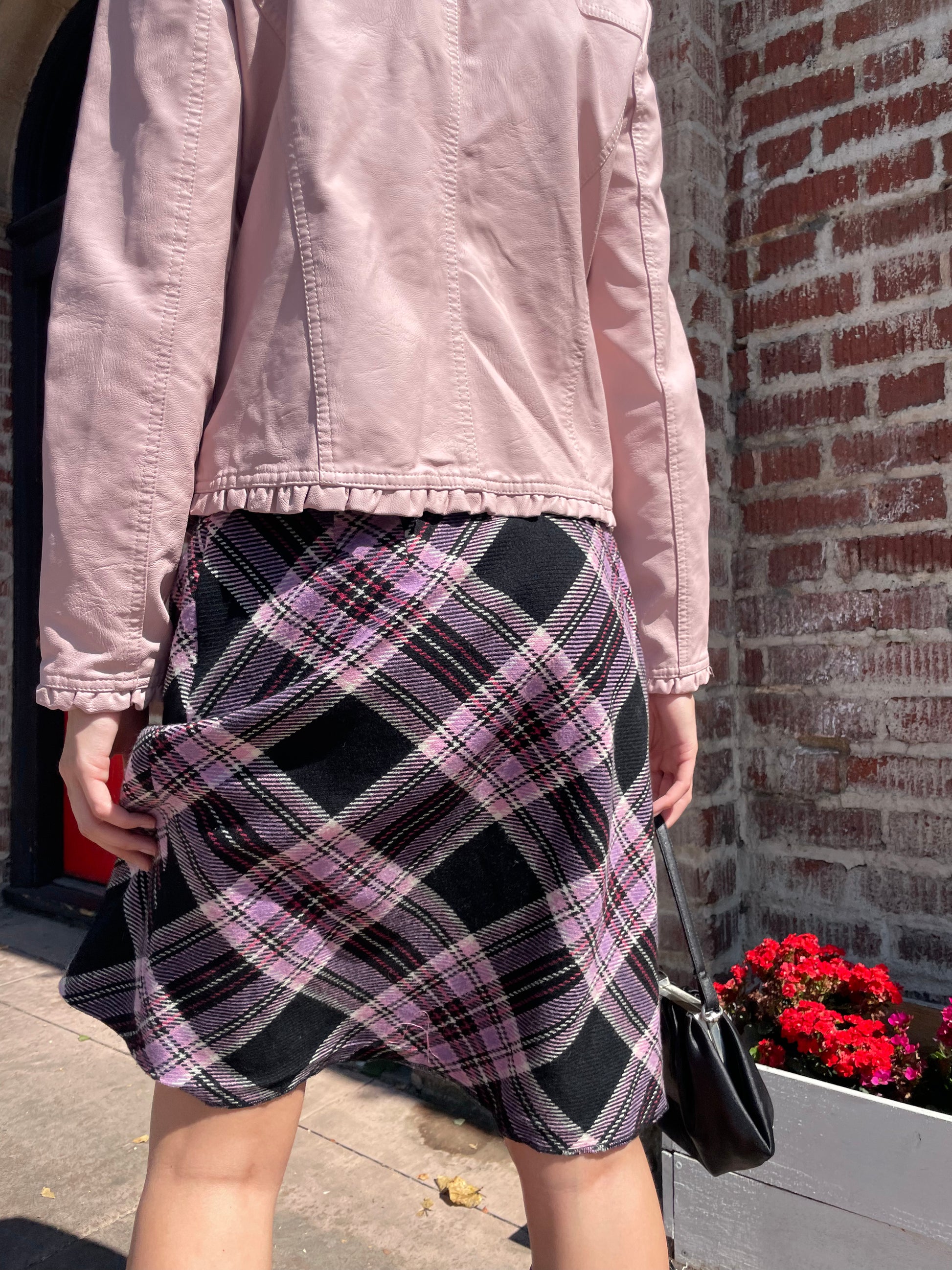 girl in plaid skirt and pink jacket