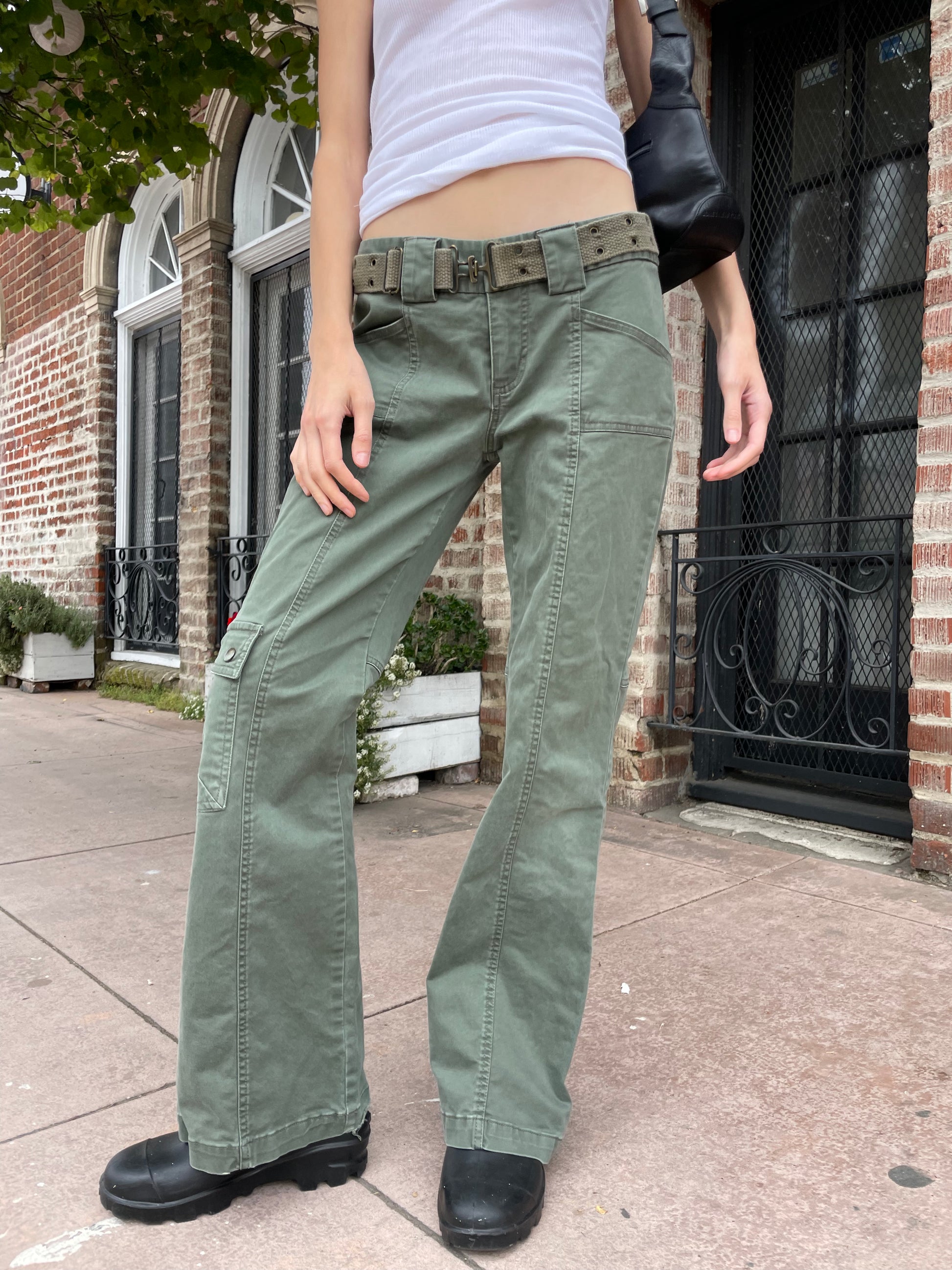 girl wearing white tank and green cargo pants