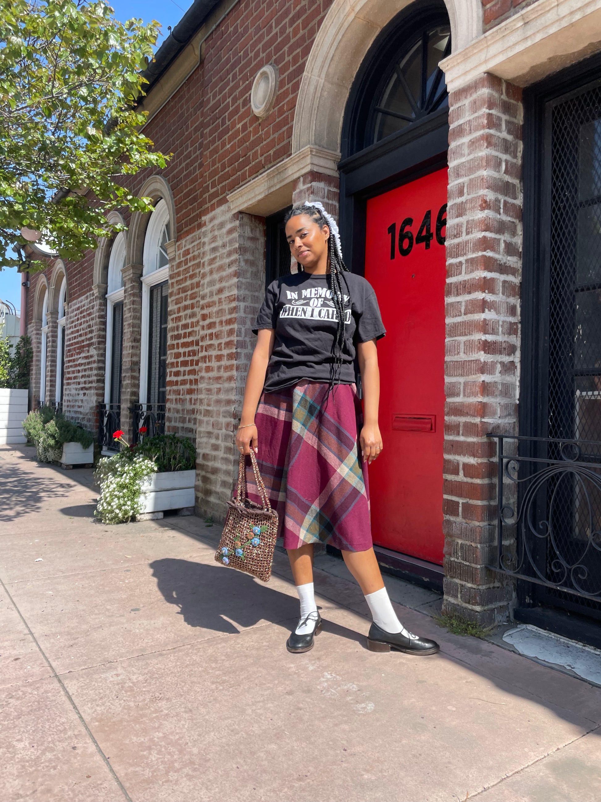 A girl wearing a tee shirt and skirt.