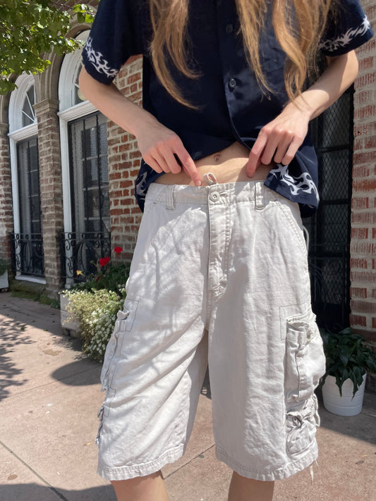 girl wearing blue button up shirt and khaki cargo shorts