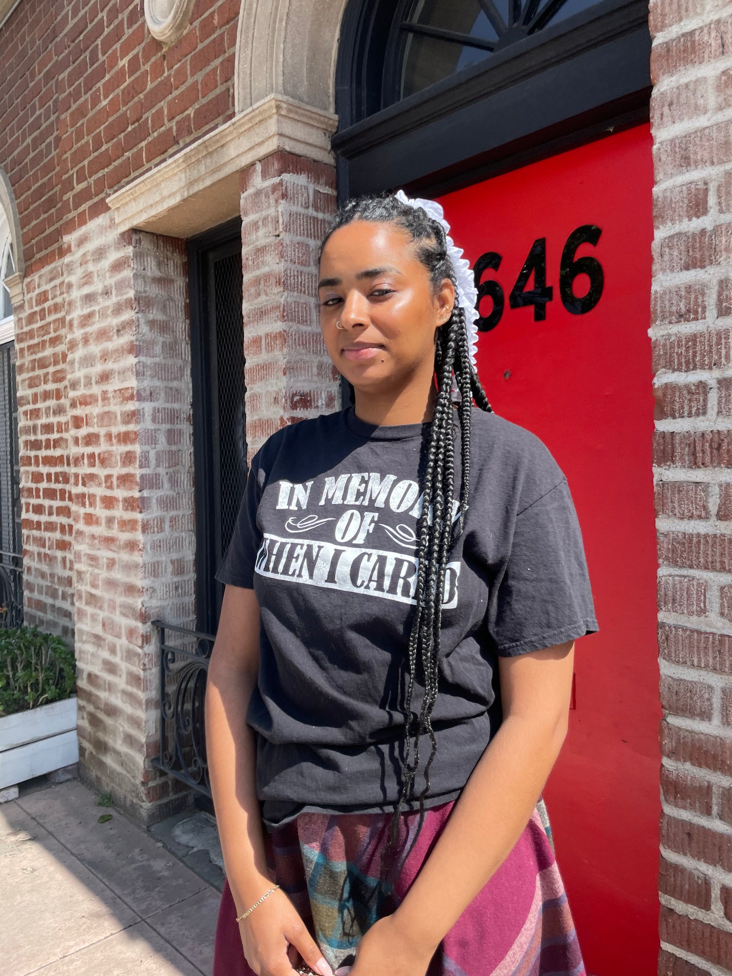 A girl wearing a tee shirt and skirt.