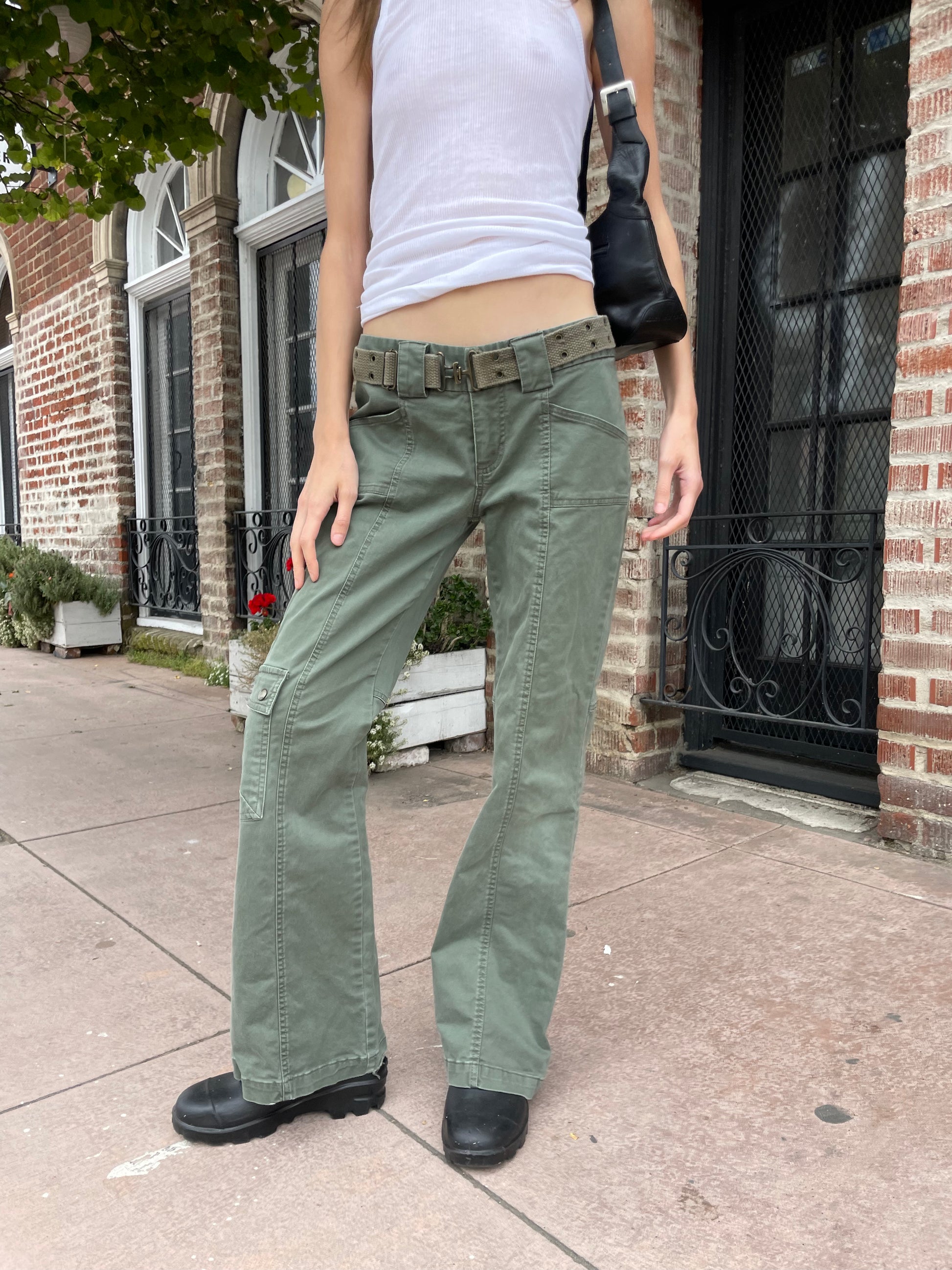 girl wearing white tank and green cargo pants