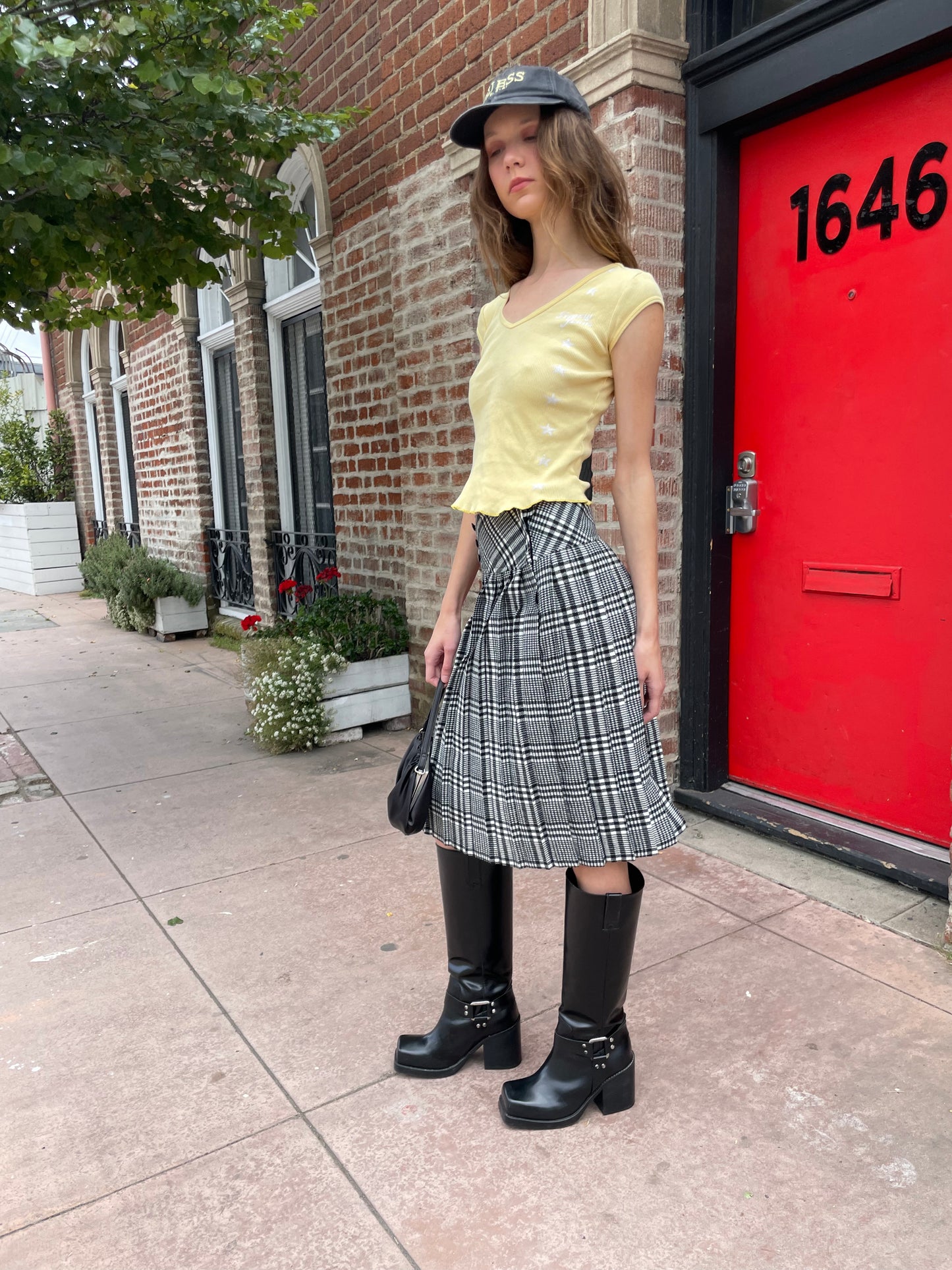 girl in yellow top and black and white skirt