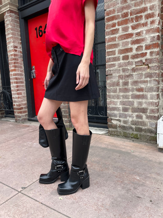 girl in black skirt and red top