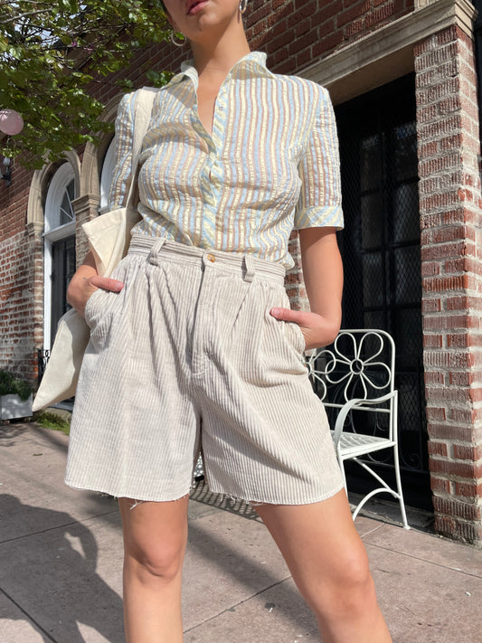 girl wearing tan shirt and shorts