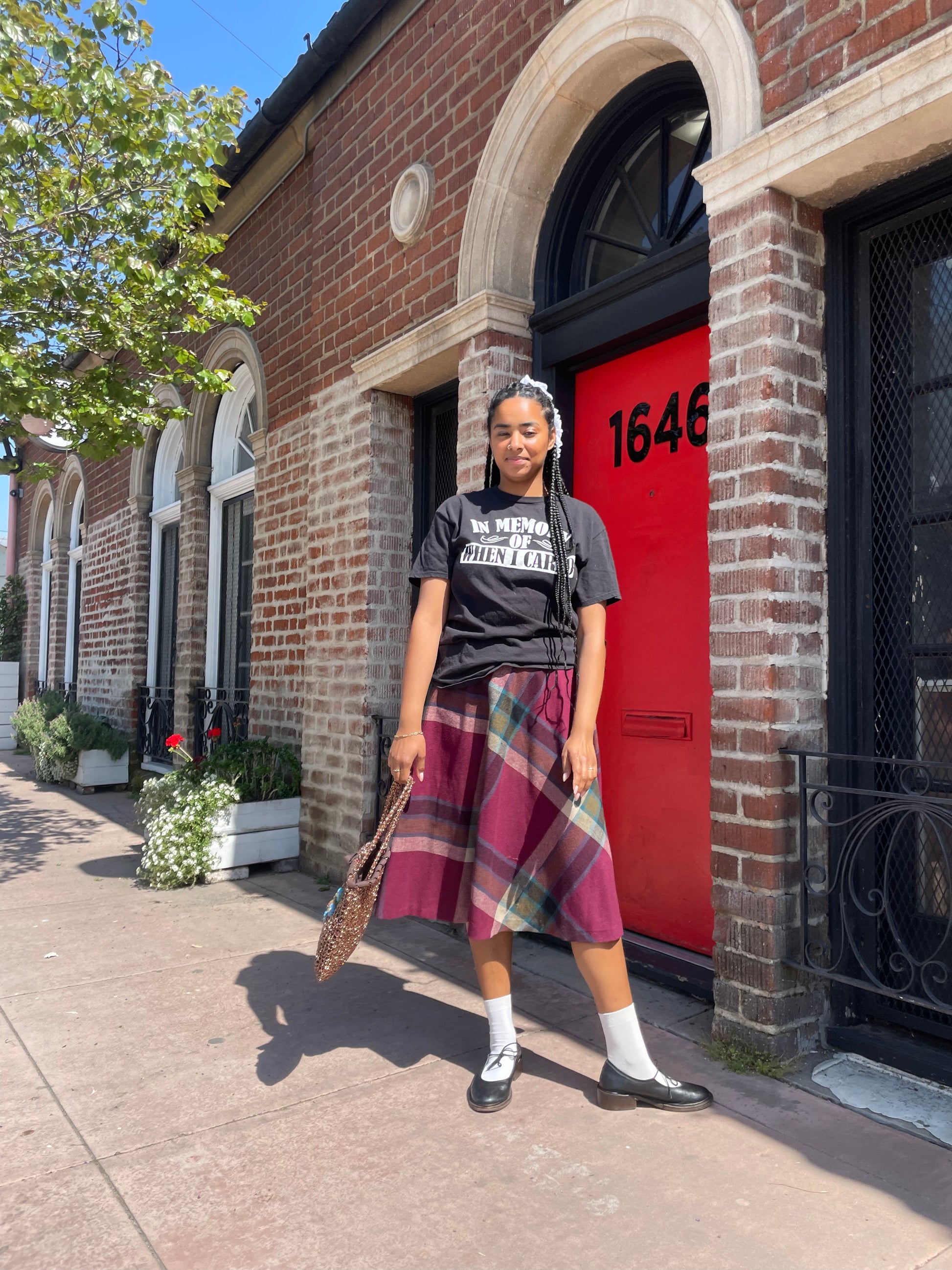 A girl wearing a tee shirt and skirt.