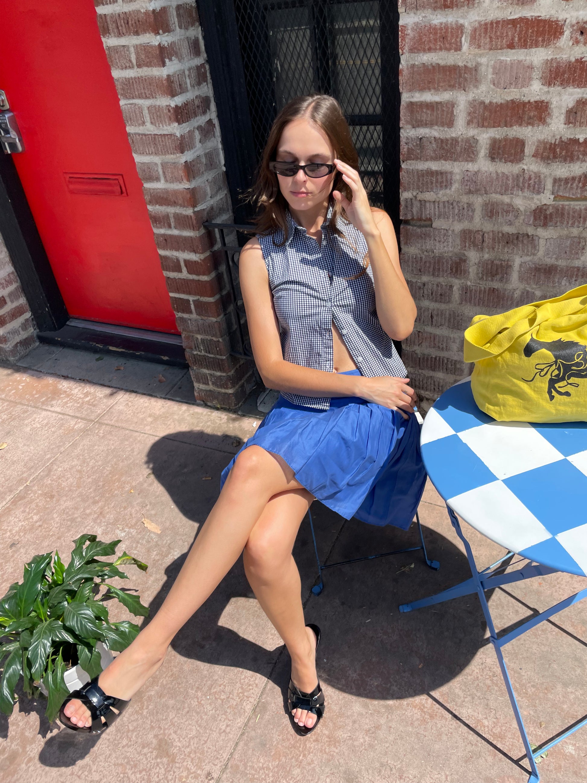 girl in blue skirt and checkered top