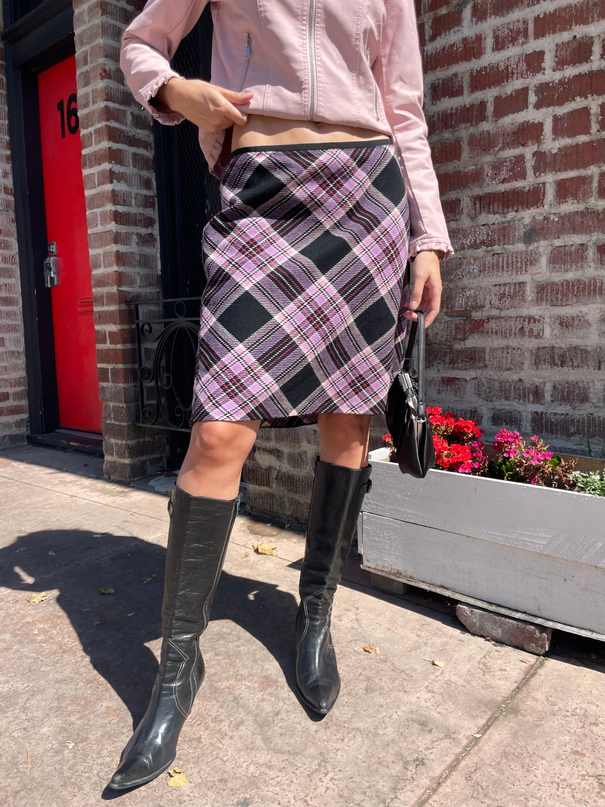 girl in plaid skirt and pink jacket