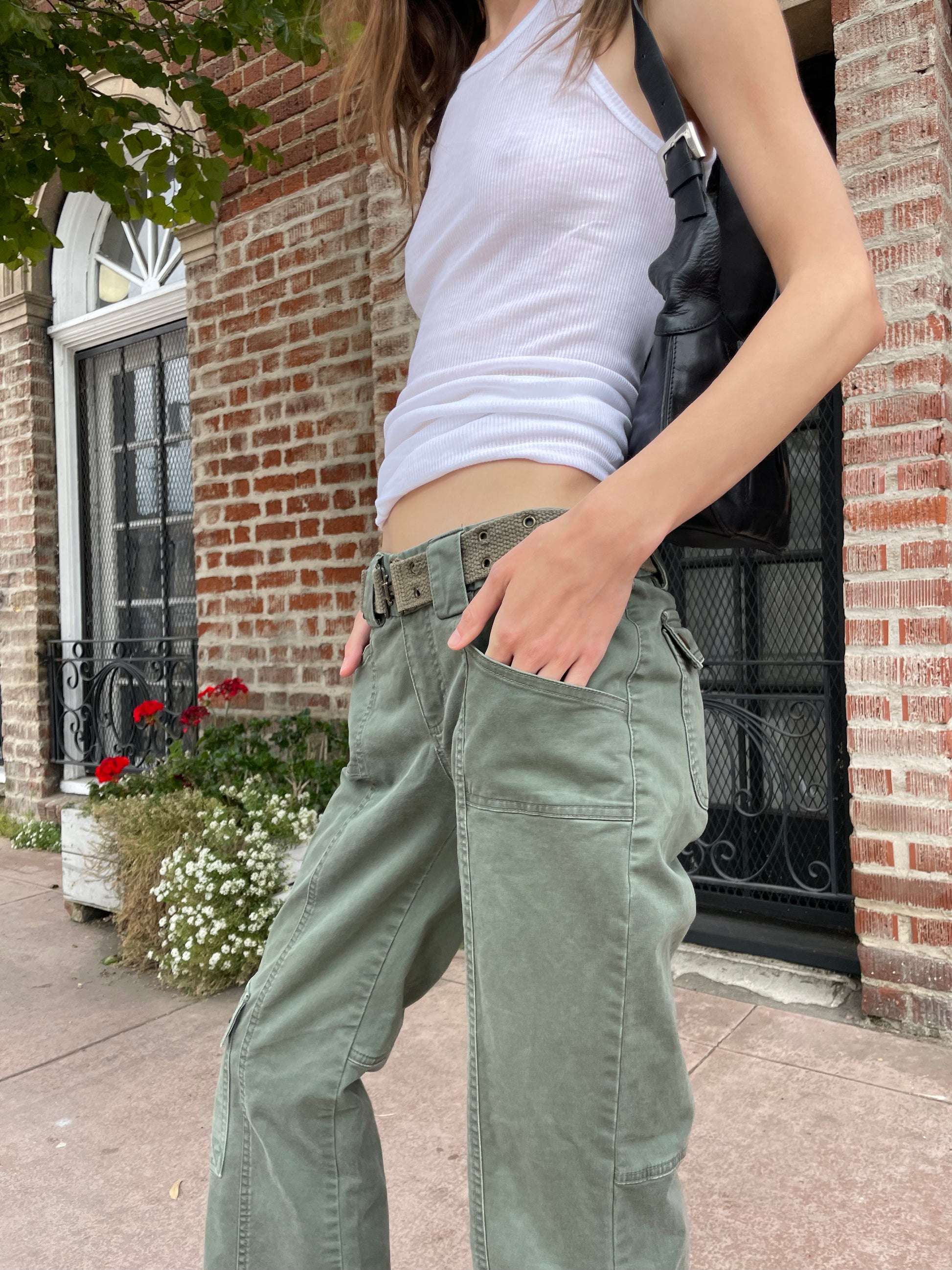 girl wearing white tank and green cargo pants