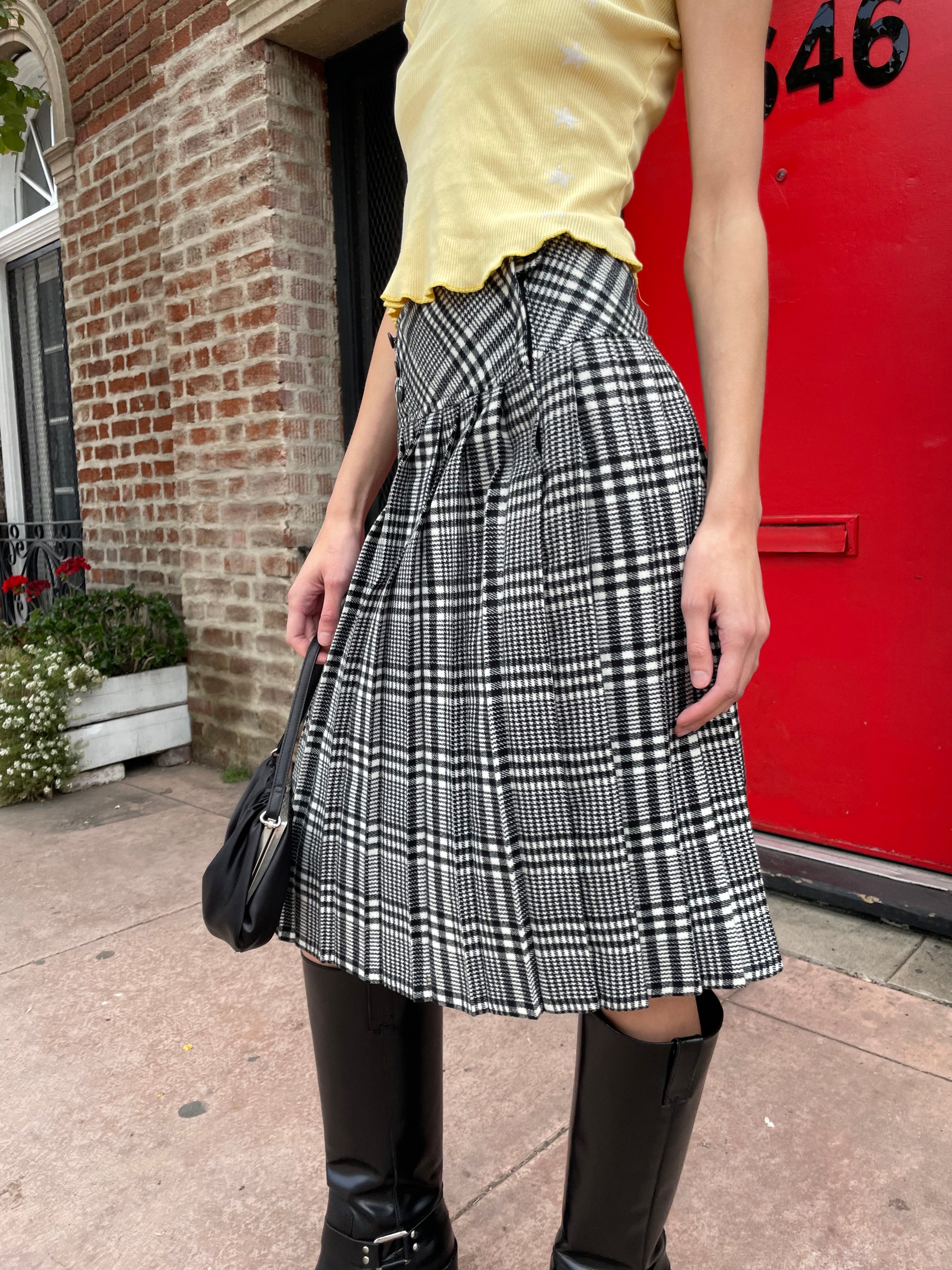 girl in yellow top and black and white skirt