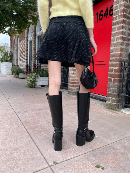 girl wearing yellow sweater and black skirt
