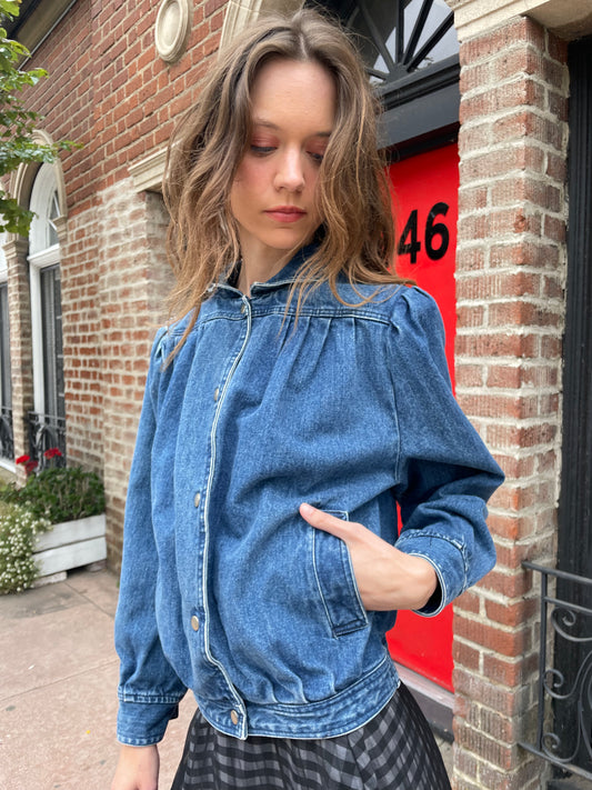 girl wearing denim jacket, gingham skirt and black boots