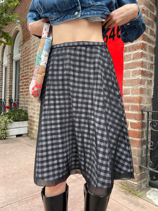 girl in plaid gingham skirt and denim jacket