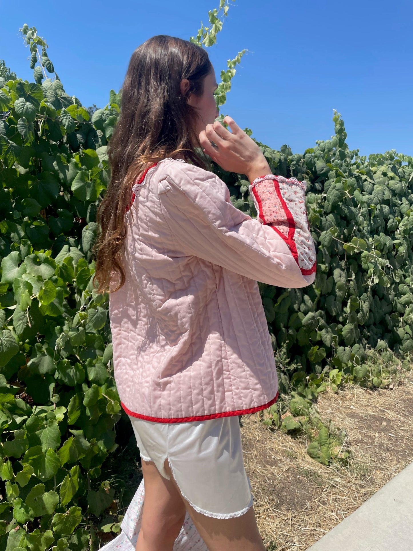 girl in pink jacket and white skirt