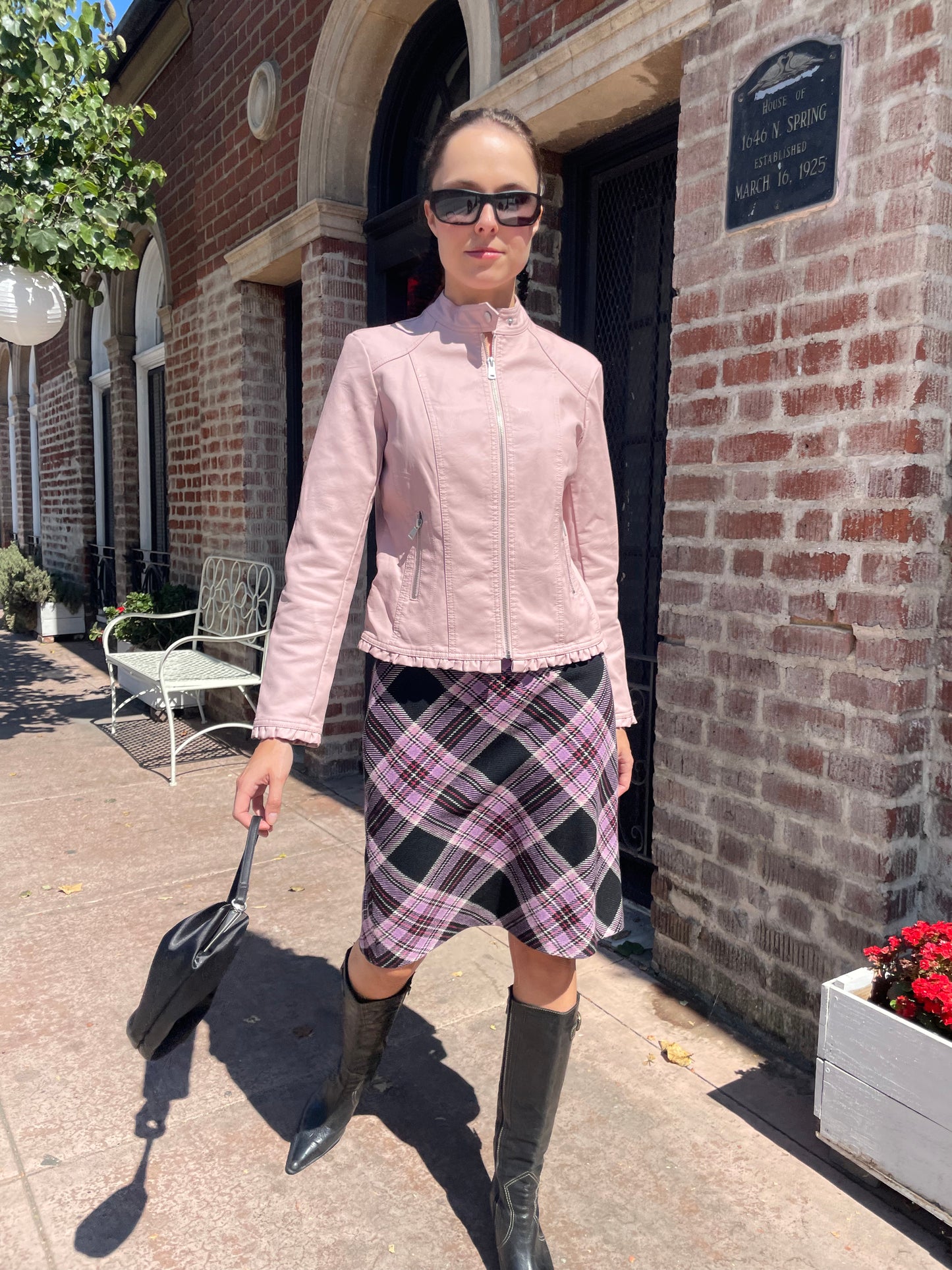 girl in plaid skirt and pink jacket