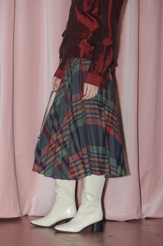 Girl wearing pleated plaid midi skirt.