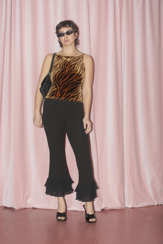 girl in animal print top and capri pants