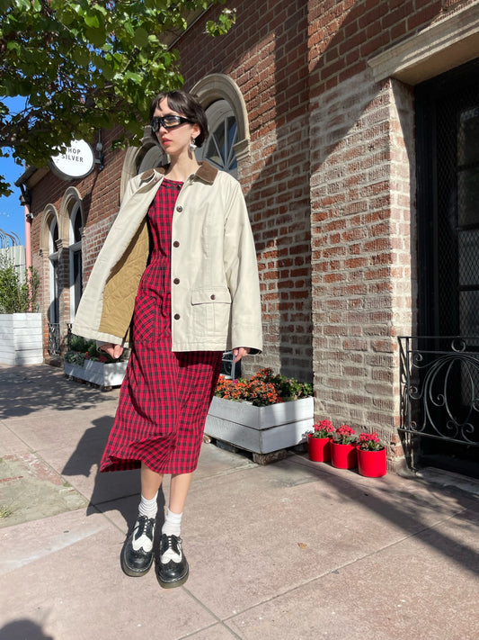 girl wearing a red dress and a tan jacket