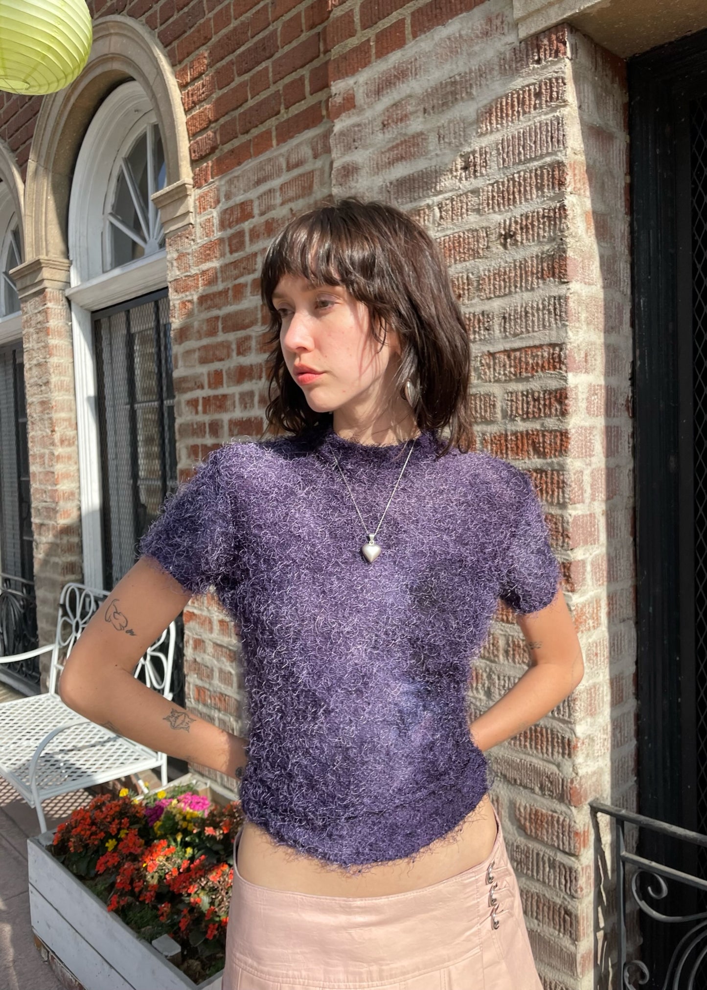 girl wearing textured purple shirt