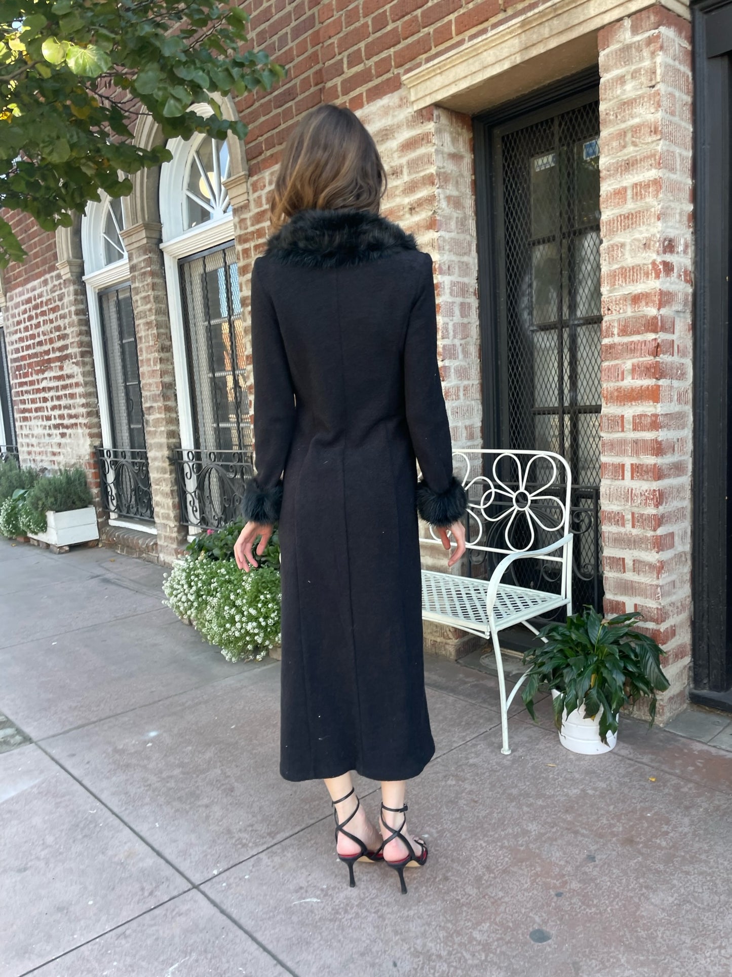 back of girl wearing a black fur collar coat