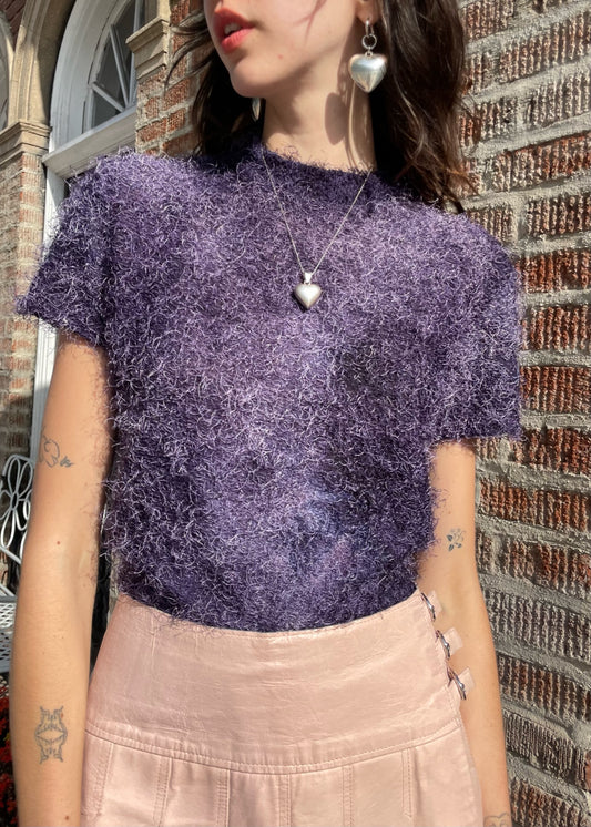 close up of girl wearing a textured purple shirt