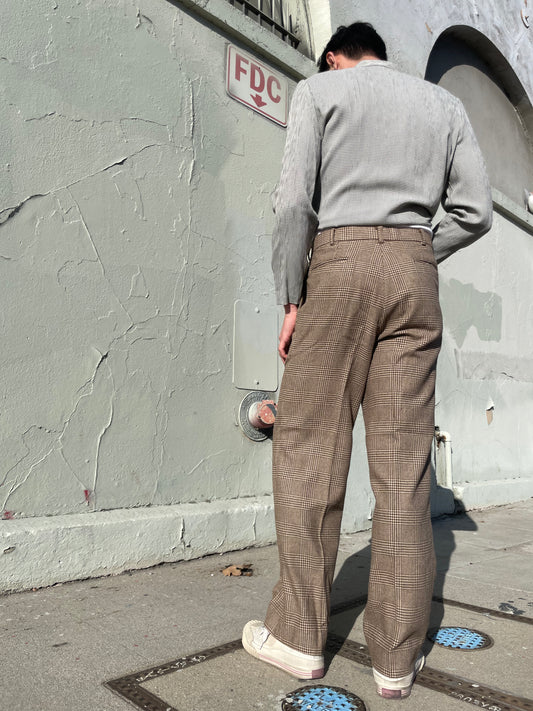 back of boy wearing grey jacket and tan slacks