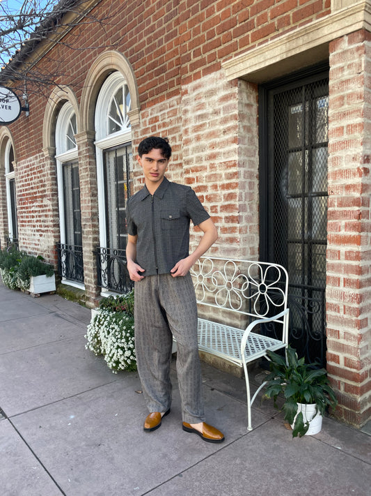 boy wearing grey pants and grey button up shirt