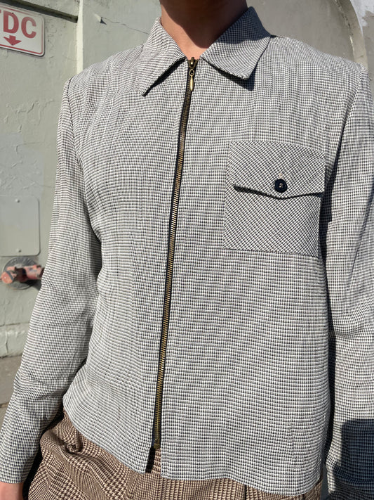 boy wearing a grey zipped up jacket