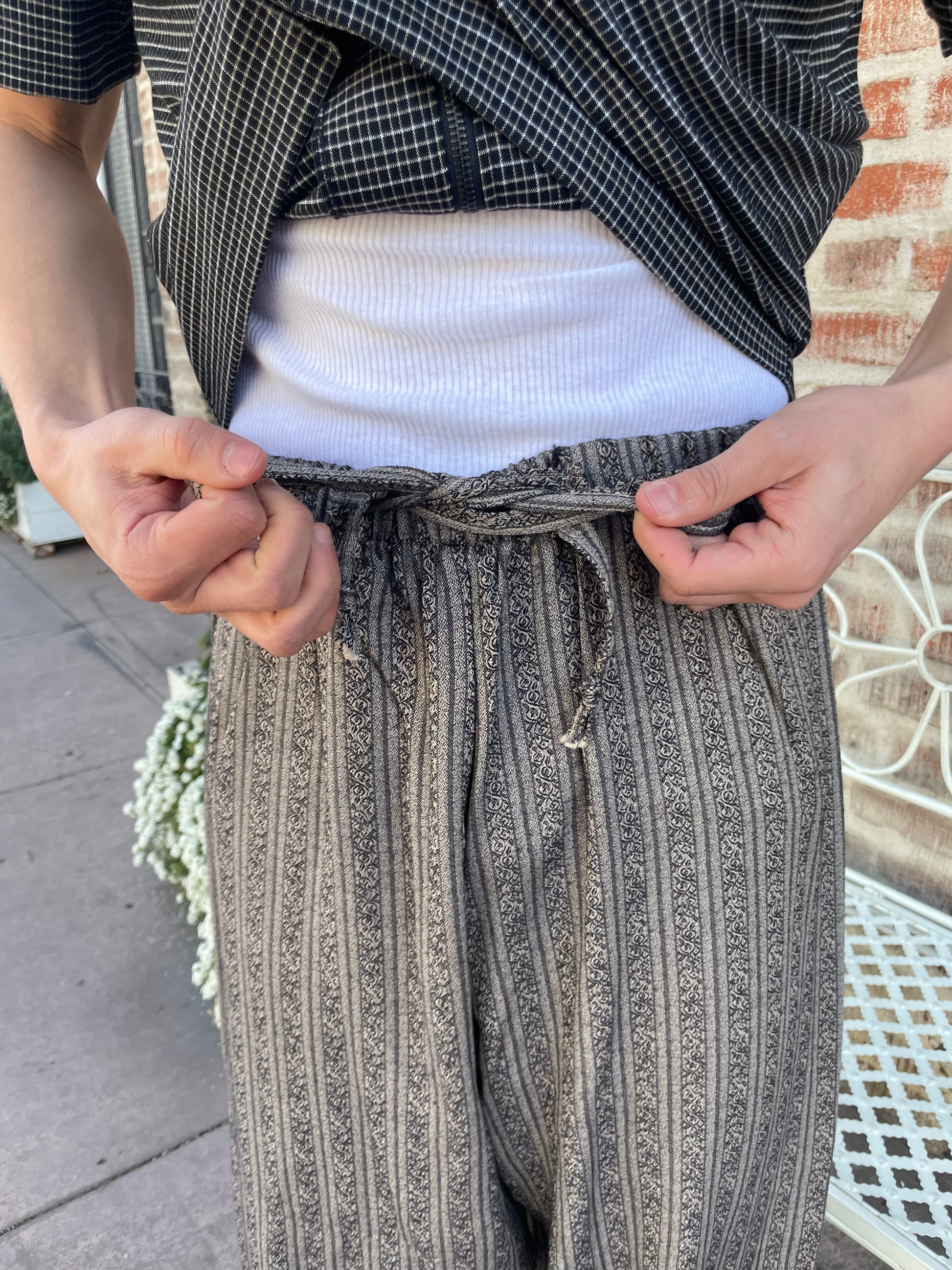 boy wearing grey pants and grey button up shirt